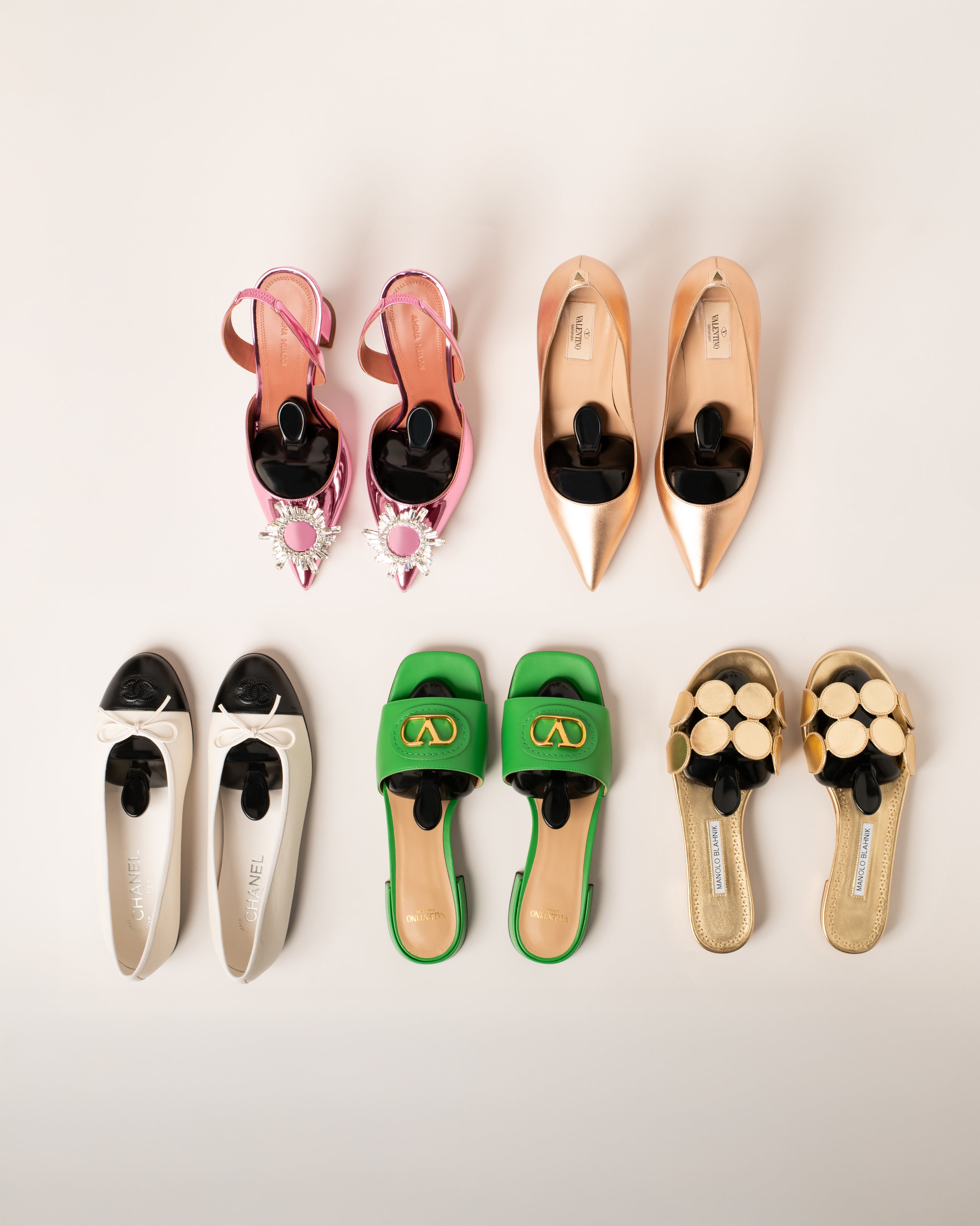 popins womens shoes trees in a collection of colorful shoes including sandals and flats on a light background